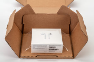 Apple AirPods 2 in shipping box, opened, white background, Apple AirPods 2 in shipping box, opened, white background,